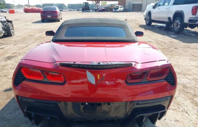 Tył czerwonego Chevroleta Corvette z uszkodzonym zderzakiem i czarnym dachem
